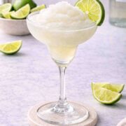 a frozen lime daiquiri with a lime on the edge of the glass