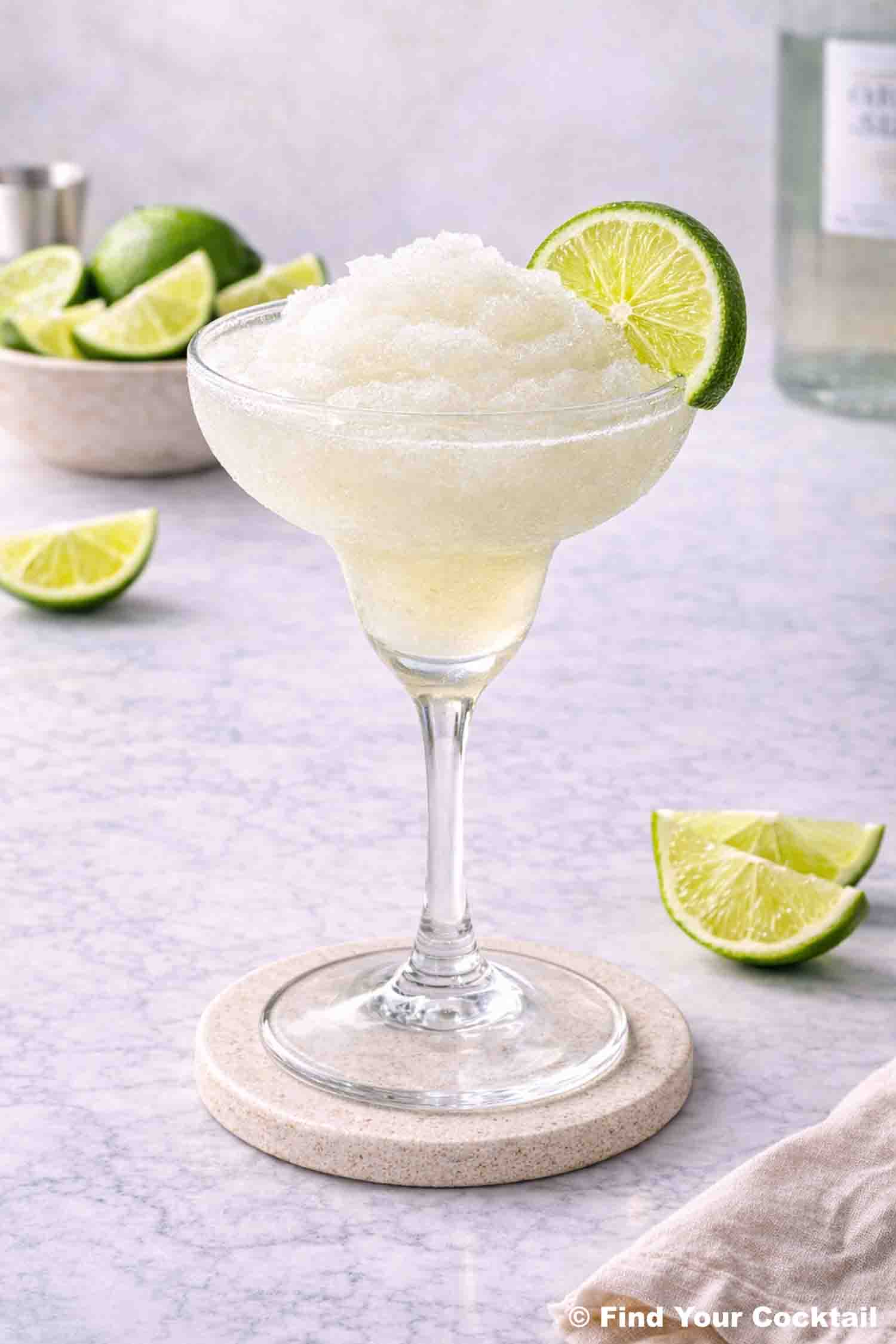 a frozen lime daiquiri with a lime on the edge of the glass