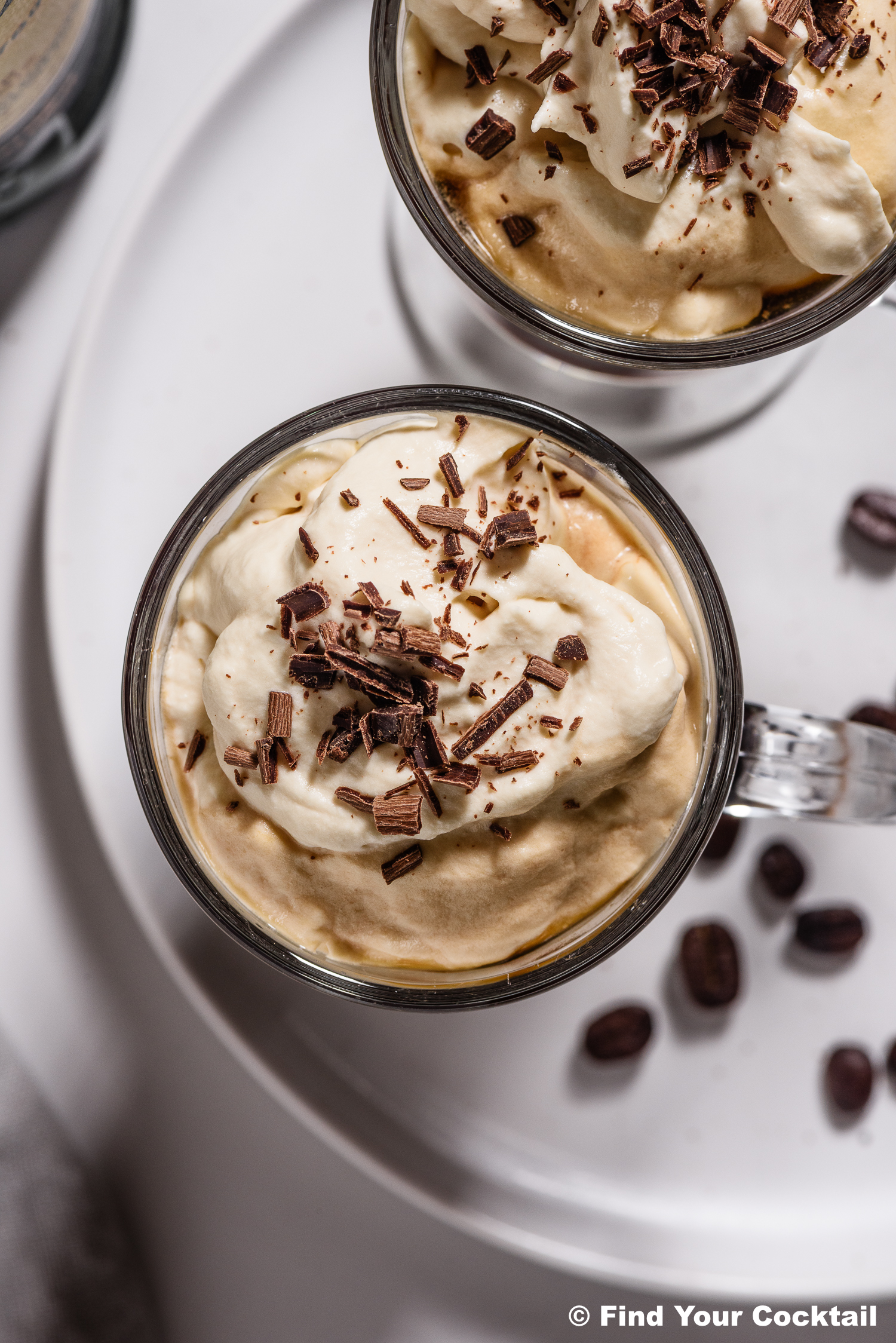 Looking down on an Irish coffee with whipped cream and chocolate shavings.