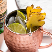 An Irish mule garnished with lime slices and ginger slices.
