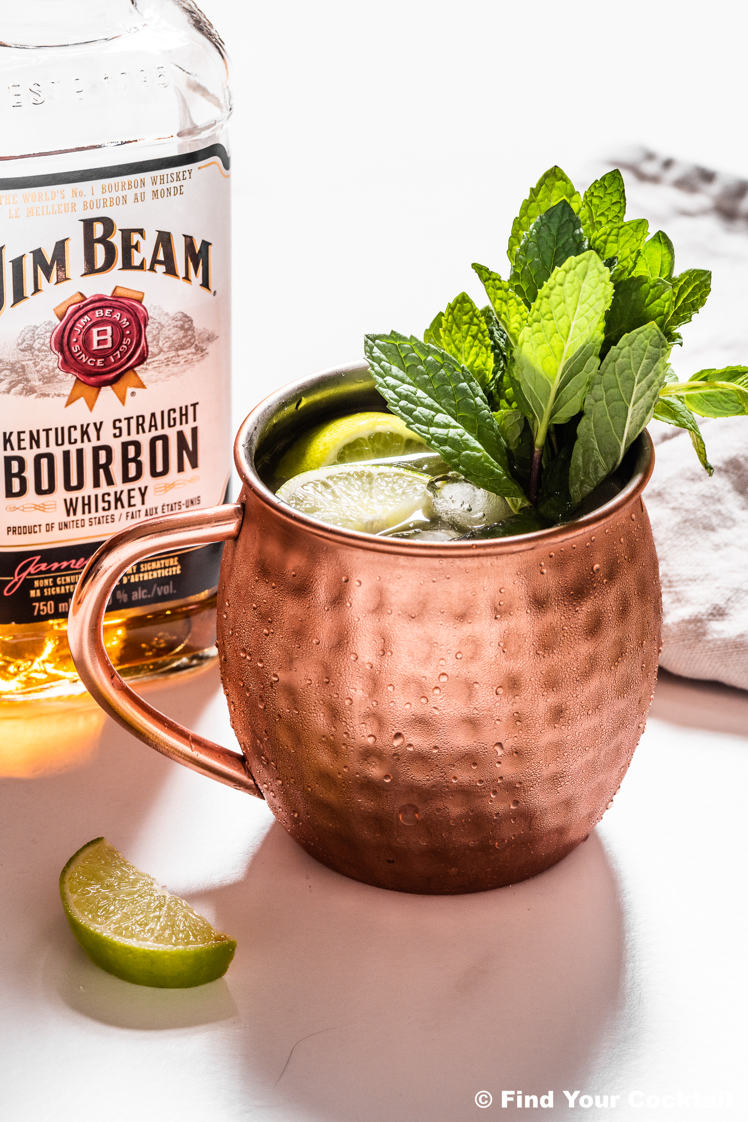 a mule mug with a bottle of bourbon in the background. 