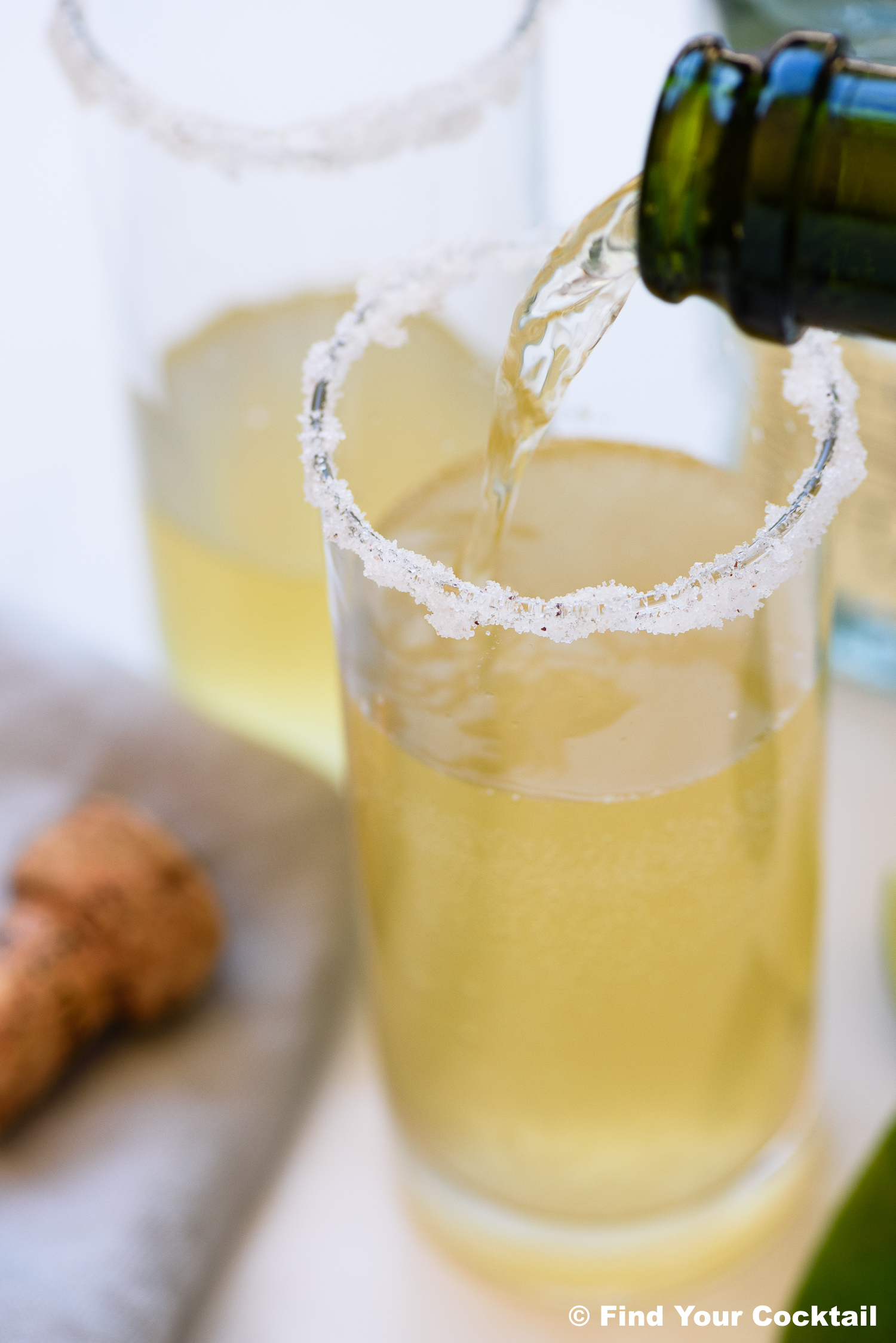 pouring sparkling wine into a glass with tequila