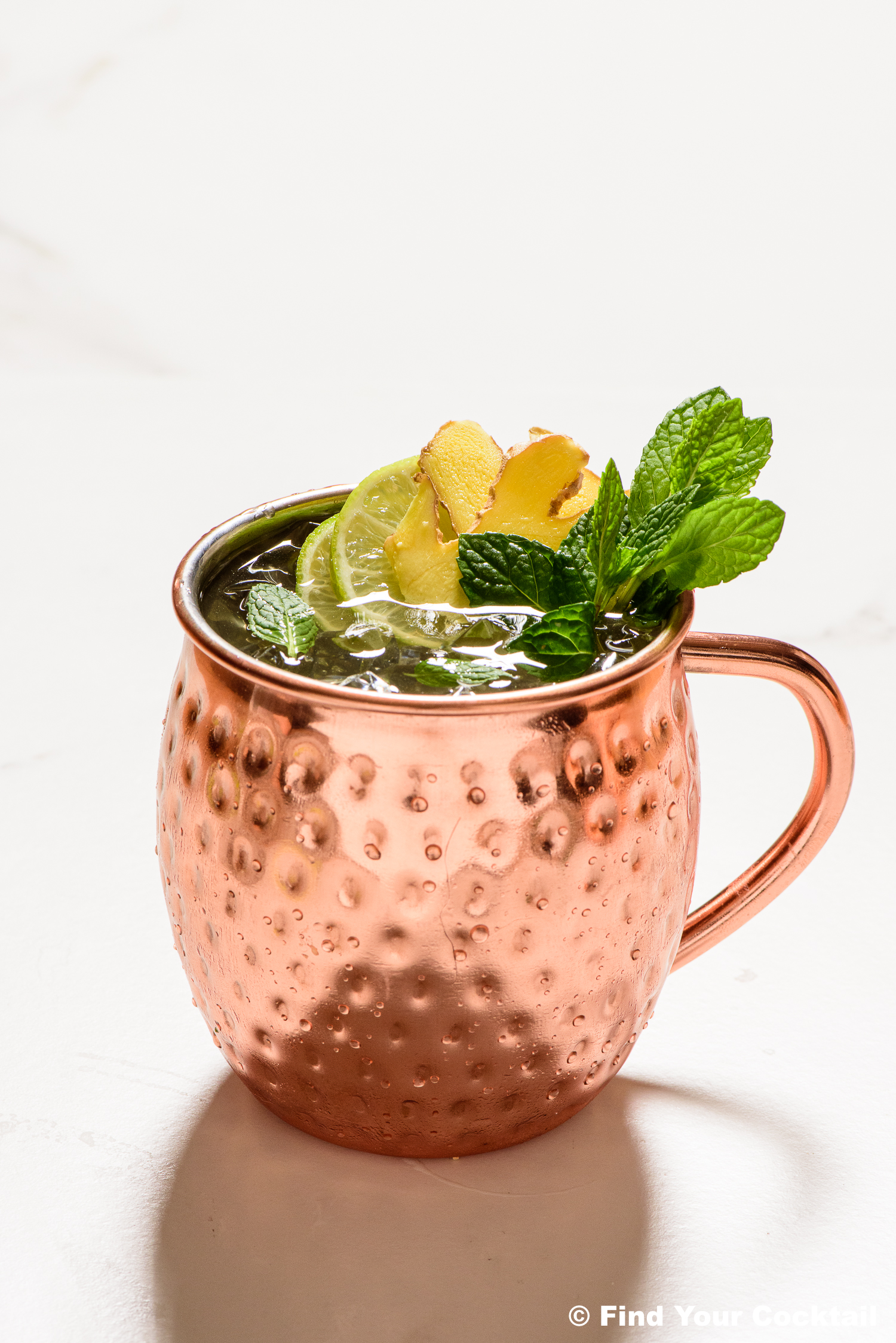 a gin mule in a copper mug on a white background