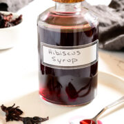 a jar with a wooden top labeled hibiscus syrup
