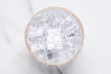 Recipe instruction photo: a glass rimmed with cinnamon sugar and filled with ice