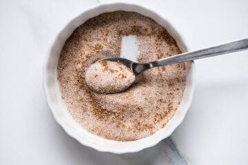 Recipe instruction photo: cinnamon sugar in a white shallow bowl