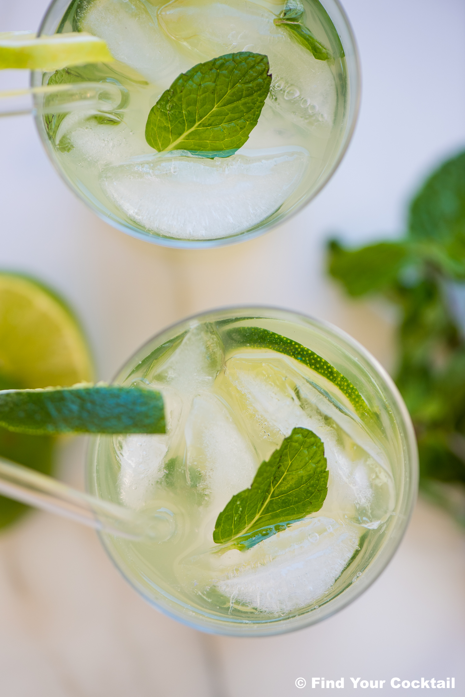 looking down on 2 mojitos in tall glasses
